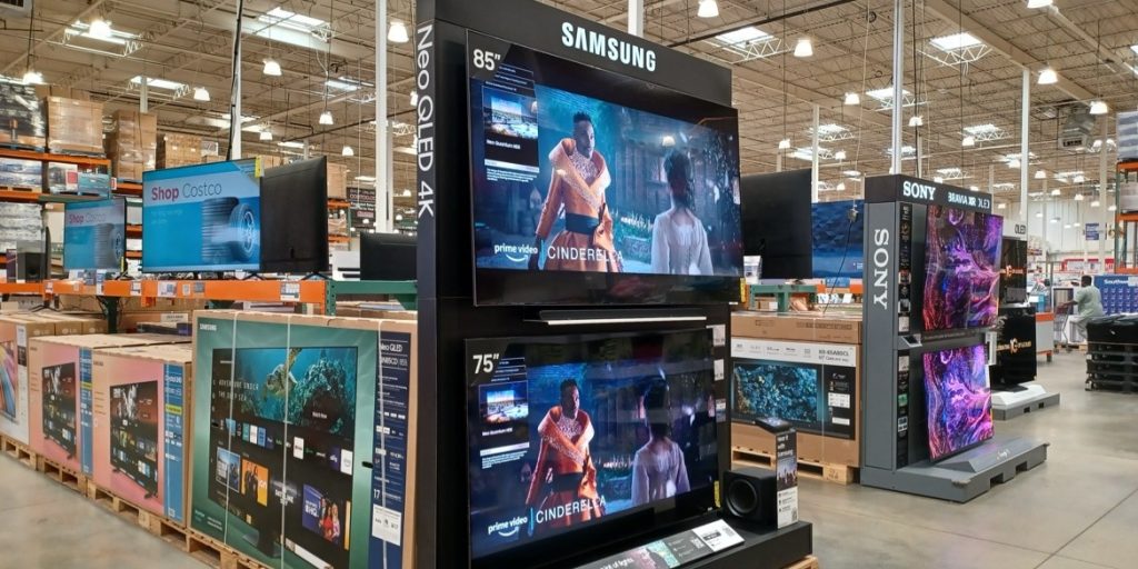 Large-screen Samsung and Sony televisions on display at a Costco warehouse store