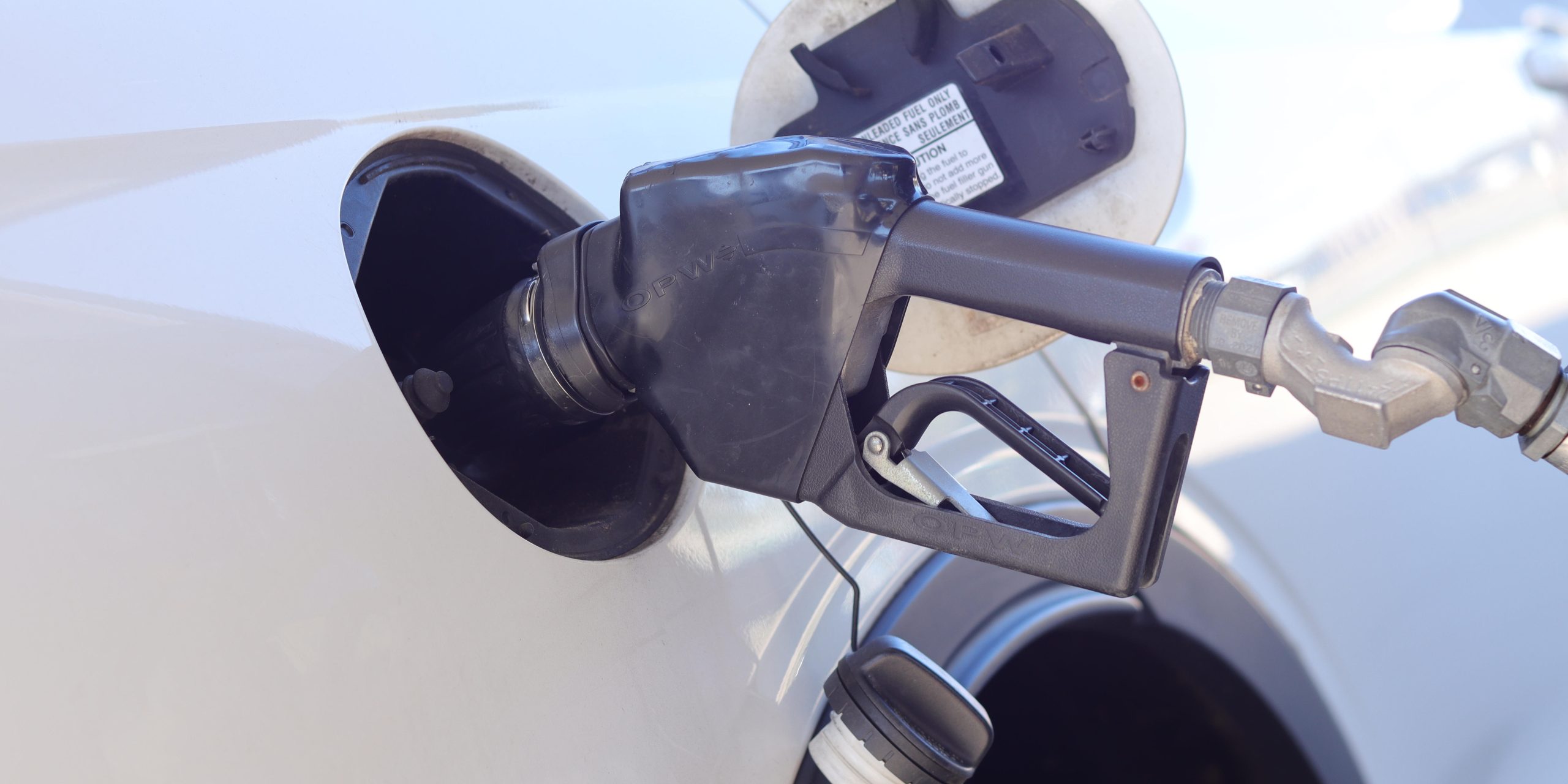 A fuel nozzle fills a car's tank