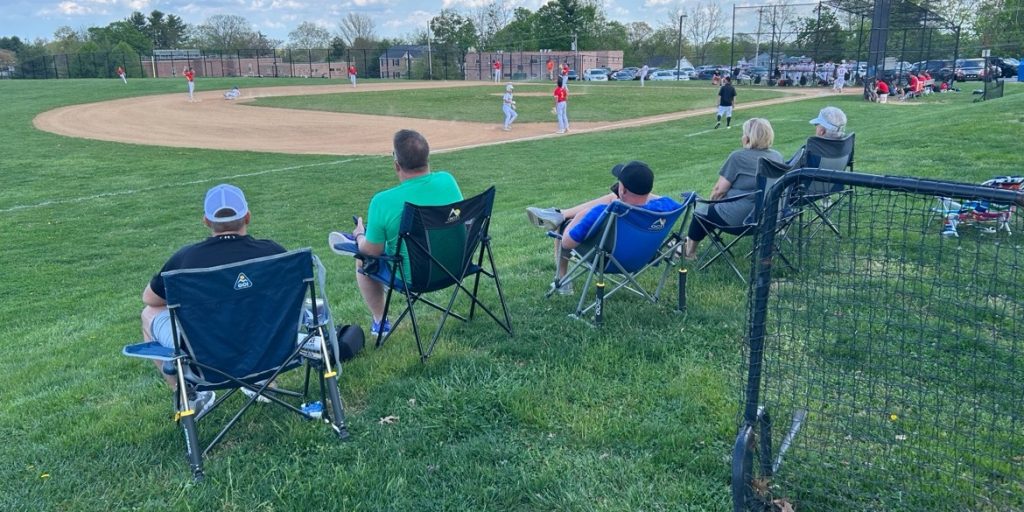 Spectators watch a Marple Newtown High School baseball home game