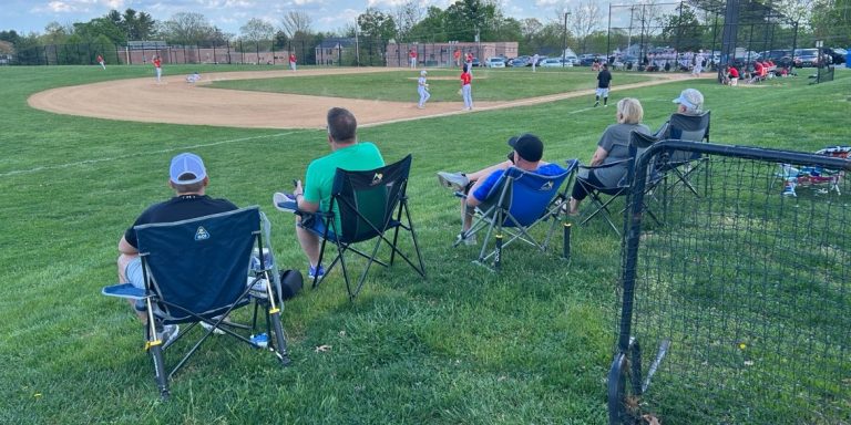 Spectators watch a Marple Newtown High School baseball home game