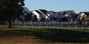 New suburban homes behind white fences in Delaware County, Pennsylvania
